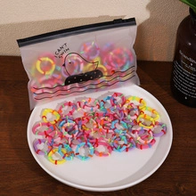 Detailed close-up of colorful soft cotton hair ties in frosted packaging with a tray