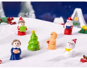 Miniature resin Christmas figurines featuring Santa and snowman in a snowy scene