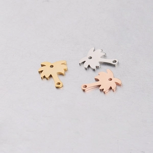 Detailed view of palm tree charms in gold, silver, and rose gold mirror finish stainless steel