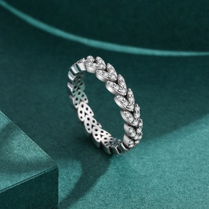 Elegant 925 sterling silver leaf ring with micro-pave zircons on a green background