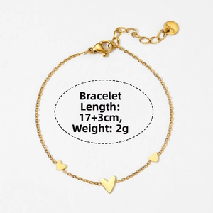 Detailed close-up of golden stainless steel heart chain bracelet with lobster clasp