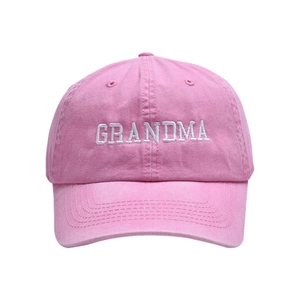 Detailed close-up of GRANDMA white embroidery on pink washed cotton baseball cap texture