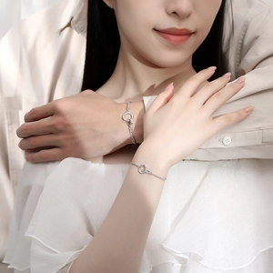 Interlocking Mobius thorn bracelets in sterling silver for couples shown on models