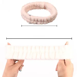 Pink coral fleece spa headband detail showing soft material and strong elasticity