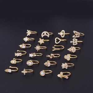 Set of 20 gold non-piercing nose rings with cubic zirconia stars hearts and moon designs