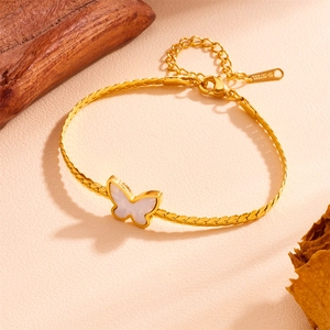 Macro detail of golden stainless steel butterfly pendant with white shell inlay