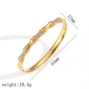 Golden bamboo texture open bangle with sparkling cubic zirconia on a white background