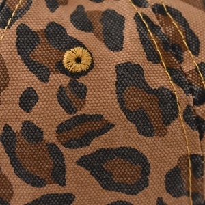 Close-up of leopard print baseball cap featuring yellow embroidered eyelets and stitching