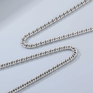 Detailed close-up of polished silver stainless steel curb chain with double weaving