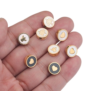 Golden stainless steel enamel beads with heart, tree of life, and angel motifs for DIY