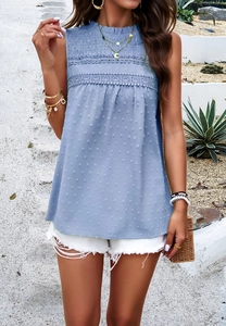 Detail of light blue sleeveless top featuring dot texture and delicate lace trim accents