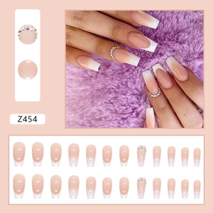 French gradient press-on nails in nude and white with rhinestones long ballet shape