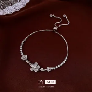 Elegant French flower zircon bracelet with adjustable silver-tone chain and silk background
