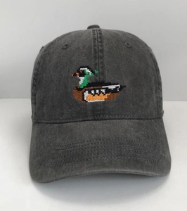 Detail of vintage gray washed cotton baseball cap with colorful duck embroidery