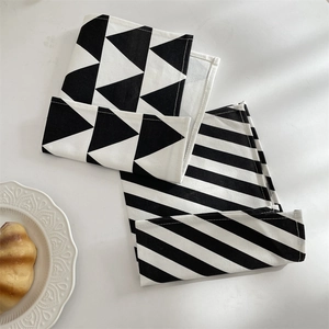 Macro view of geometric black and white linen table napkins with pattern details