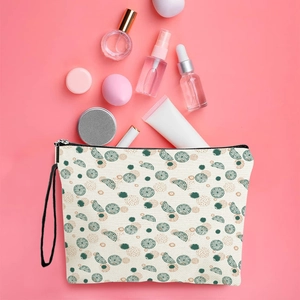 Canvas cosmetic bag with citrus print, zipper closure and wristlet strap on pink background