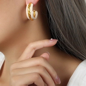 Retro C-shape hoop earrings with cream enamel and gold plated braided metal texture
