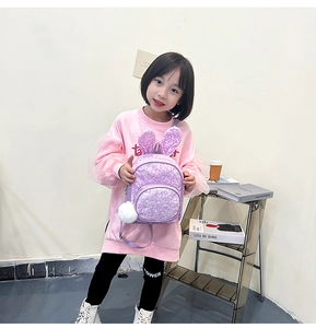 Detail of purple sequin toddler backpack with cute bunny ears and soft pompom pendant