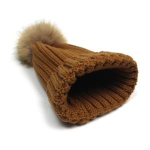 Cozy caramel knit beanie featuring a fluffy faux fur pom-pom for winter warmth and style