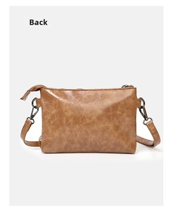 Detail view of the brown PU leather back of the crossbody bag with lychee texture