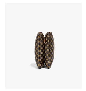 Detail of dual pouch design featuring vintage polka dot pattern and gold D-ring hardware