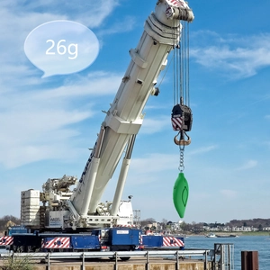 Creative display of 26g leaf-shaped personal alarm lifted by a crane to show light weight