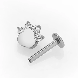 G23 titanium labret piercing stud featuring a silver animal paw print with clear crystals