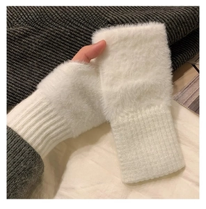 Detail of white faux fur fingerless gloves with ribbed cuffs for winter warmth