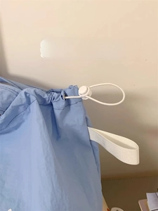 Close-up of the light blue canvas tote bag showing adjustable drawstring detail