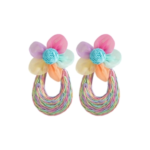 Close-up of handmade raffia teardrop earrings with colorful mesh flowers in summer style