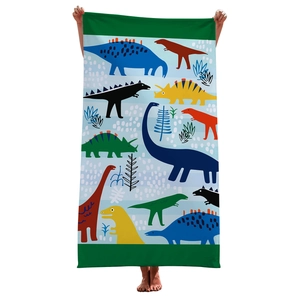 Detailed view of microfiber beach towel featuring colorful dinosaur patterns held by hands
