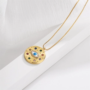 Detailed view of a gold evil eye pendant with colorful gemstones and zircon on a box chain