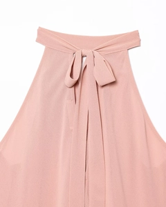 Detail of pink halter neck top with textured chiffon fabric and elegant bow-tie closure