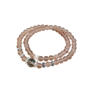 Double-layered strawberry quartz beaded bracelet with silver accents on white background