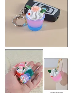 Miniature resin cream cupcake keychain with detailed floral topping and colorful finish