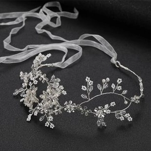 Close-up of bridal hair vine with white pearls and clear crystals on silver wire