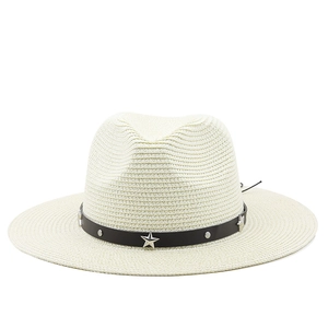 Detailed texture of beige woven straw hat with star-studded black leather band