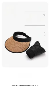 Detail view of straw sun hats with UPF50+ protection and stylish metal logo accents