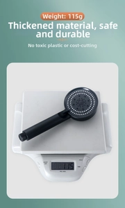 Matte black handheld shower head weighing 115g with silicone nozzles and sleek design