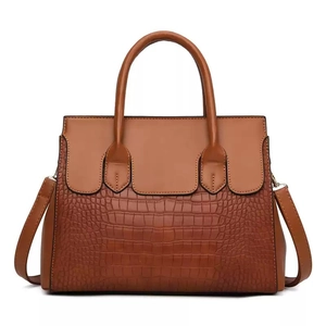 Brown vintage handbag set with crocodile pattern and dual handles in a classic tote design