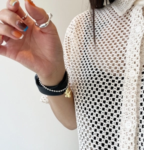Detail of 925 sterling silver irregular open rings and silver bead bracelet on hand