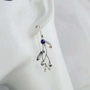 Vintage silver branch drop earrings with lapis lazuli stone on an ear model