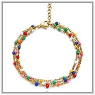 Detailed view of 18K gold bead chain layered anklet with vibrant multicolor beads