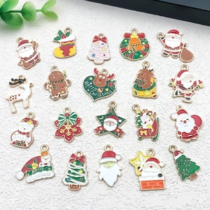 Flat lay of colorful Christmas DIY charms including Santa, elk, and trees for jewelry making