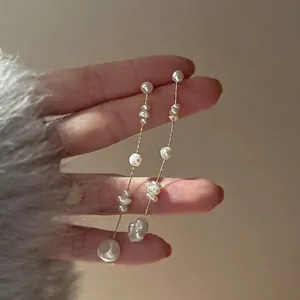 French vintage baroque freshwater pearl tassel earrings with gold chain on model hand