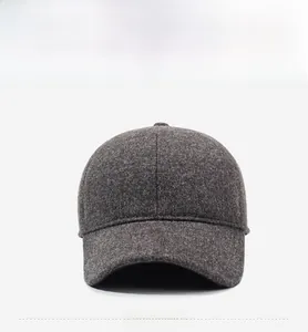 Detail of dark grey wool blend baseball cap with a premium metallic D logo emblem