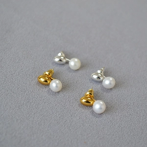 Elegant gold and silver brass stud earrings featuring natural freshwater pearls