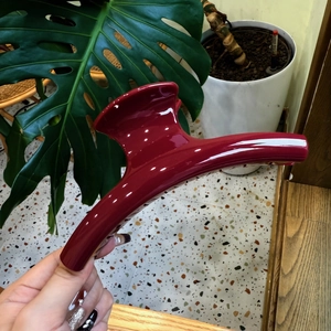 Detailed view of a 15cm large deep red glossy hair claw clip with a sleek finish