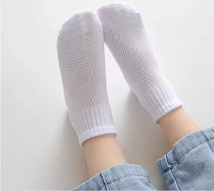 Detail of white mesh breathable cotton socks for children shown in a top view perspective