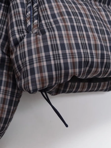 Detailed view of the plaid fabric texture with a hidden zipper and adjustable hem drawstring
